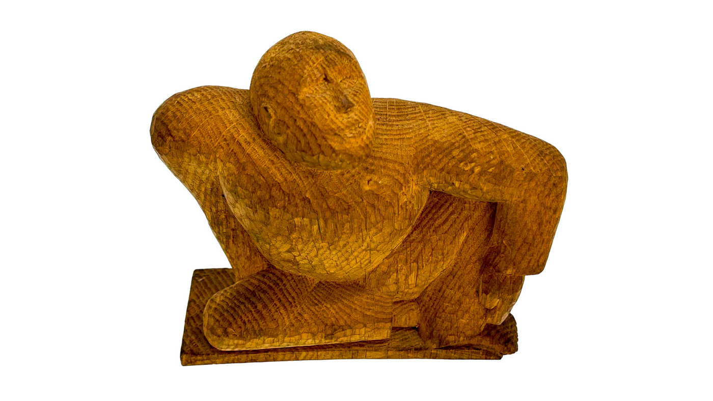 Signed hand carved/hewn figure of a seated man