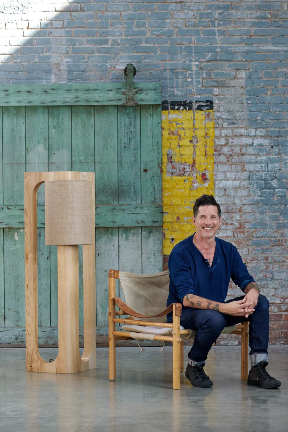 Michael seated beside a Prague floor lamp